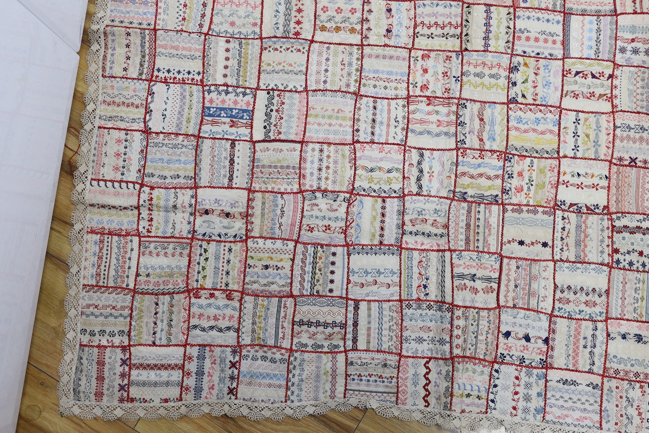A French early 20th century ribbon patchwork cover with lace trimmimg